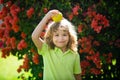 Little child with red apple on head outdoor. Royalty Free Stock Photo