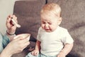 The little child refuses to eat. Mom does not have enough time for family, Mom with a small child who refuses to eat Royalty Free Stock Photo