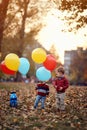 ChildÃ¢â¬â¢s brothers playing together on the autumn park with balloons. Happy childhood
