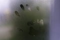 Little child`s handprint on foggy rainy glass Royalty Free Stock Photo