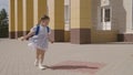 Little child with school backpack having fun spin in school yard, happy dreamy kid, first grader loves to play dizzying Royalty Free Stock Photo