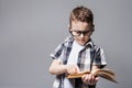 Little child with school bag and book in studio Royalty Free Stock Photo