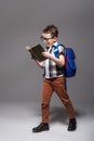 Little child with school bag reading a book Royalty Free Stock Photo