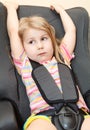 Little child sits in a car seat