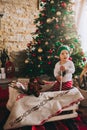 Little child sitting on the floor near the Christmas tree Royalty Free Stock Photo