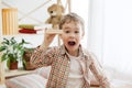 Little child sitting on the floor. Pretty boy palying with wooden cubes at home