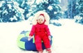 Little child sitting on sled in winter Royalty Free Stock Photo