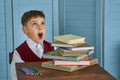 Little child stressed tired leaning on pile of books