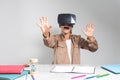 Little child studying with vr glasses for homework and online classes at desk. Young girl with headset preparing for Royalty Free Stock Photo