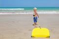 Little child swimming with bodyboard on the sea sand beach Royalty Free Stock Photo