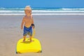 Little child swimming with bodyboard on the sea sand beach Royalty Free Stock Photo