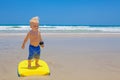 Little child swimming with bodyboard on the sea sand beach Royalty Free Stock Photo