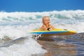 Little child swimming with bodyboard on the sea waves Royalty Free Stock Photo
