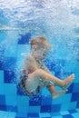 Little child swimming with fun and diving down in pool Royalty Free Stock Photo