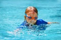 Little child swimming lesson in outdoor pool