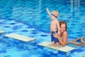 Little child swimming in pool with mother Royalty Free Stock Photo