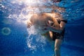 Little child swims underwater in swimming pool Royalty Free Stock Photo