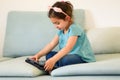 Little Child With Tablet On Couch.