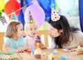 Little child and their mother celebrate birthday party with colorful decoration and cakes with colorful decoration and cake Royalty Free Stock Photo