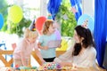 Little child and their mother celebrate birthday party with colorful decoration and cakes with colorful decoration and cake