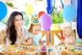 Little child and their mother celebrate birthday party with colorful decoration and cakes with colorful decoration and cake Royalty Free Stock Photo