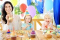 Little child and their mother celebrate birthday party with colorful decoration and cakes with colorful decoration and cake Royalty Free Stock Photo