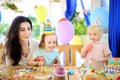 Little child and their mother celebrate birthday party with colorful decoration and cakes with colorful decoration and cake Royalty Free Stock Photo