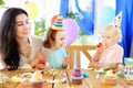 Little child and their mother celebrate birthday party with colorful decoration and cakes with colorful decoration and cake Royalty Free Stock Photo