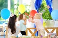 Little child and their mother celebrate birthday party with colorful decoration and cakes with colorful decoration and cake Royalty Free Stock Photo