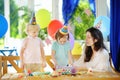 Little child and their mother celebrate birthday party with colorful decoration and cakes with colorful decoration and cake Royalty Free Stock Photo