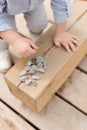 little child is touching stones. wood texture