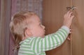 Little child try to open the door at home Royalty Free Stock Photo