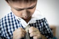 Little child is trying to wear shirt,student button or unbutton his shirt at home,kid boy kindergarten self study learning to Royalty Free Stock Photo