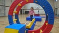 A little girl balancing on a gymnastics beam