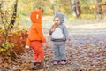 Little children in animal costumes playing in autumn forest Royalty Free Stock Photo