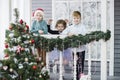 Little children In anticipation of new year and Christmas. Three little Kids are having fun and playing near Christmas tree