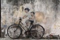 Little Children on a Bicycle street art mural by Lithuanian artist Ernest Zacharevic in Georgetown, Penang, Malaysia. Royalty Free Stock Photo