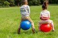 little children bouncing on hopper balls at park