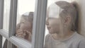 Little children boy and girl standing behind the door with glass inserts. Action. Sister and brother standing excited Royalty Free Stock Photo