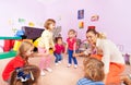 Little children boys, girls squat play roundelay Royalty Free Stock Photo