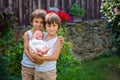 Little children, boys with a newborn brother in the park Royalty Free Stock Photo