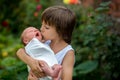 Little children, boys with a newborn brother in the park Royalty Free Stock Photo