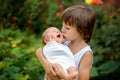 Little children, boys with a newborn brother in the park Royalty Free Stock Photo