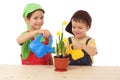 Little children caring for potted narcissus