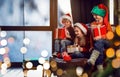 Little children with Christmas gifts near window. Presents from Santa Claus Royalty Free Stock Photo