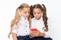 Little children depend on mobile phone. Girls text sms with mobile phone. depend. Royalty Free Stock Photo