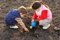 Little children on field seeding the plant
