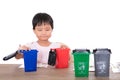Little children in front of white background are playing sorting garbage bin model Royalty Free Stock Photo