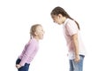 Little children, girlfriends in pink sweaters and jeans shout at each other. Anger and stress. Isolated over white background Royalty Free Stock Photo