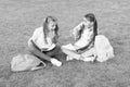 Little children girls read books sit on grass, knowledge day concept Royalty Free Stock Photo